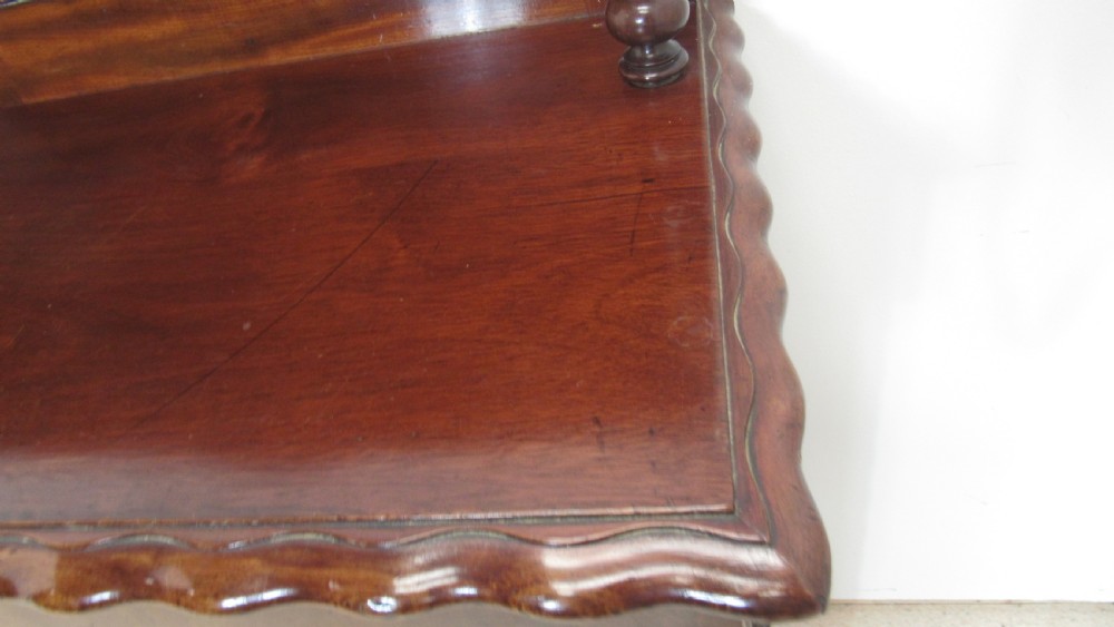 A Victorian mahogany chiffonier featuring an upper gallery shelf with turned side supports above a two-door lower cabinet with arched moulded panels. View XVIII