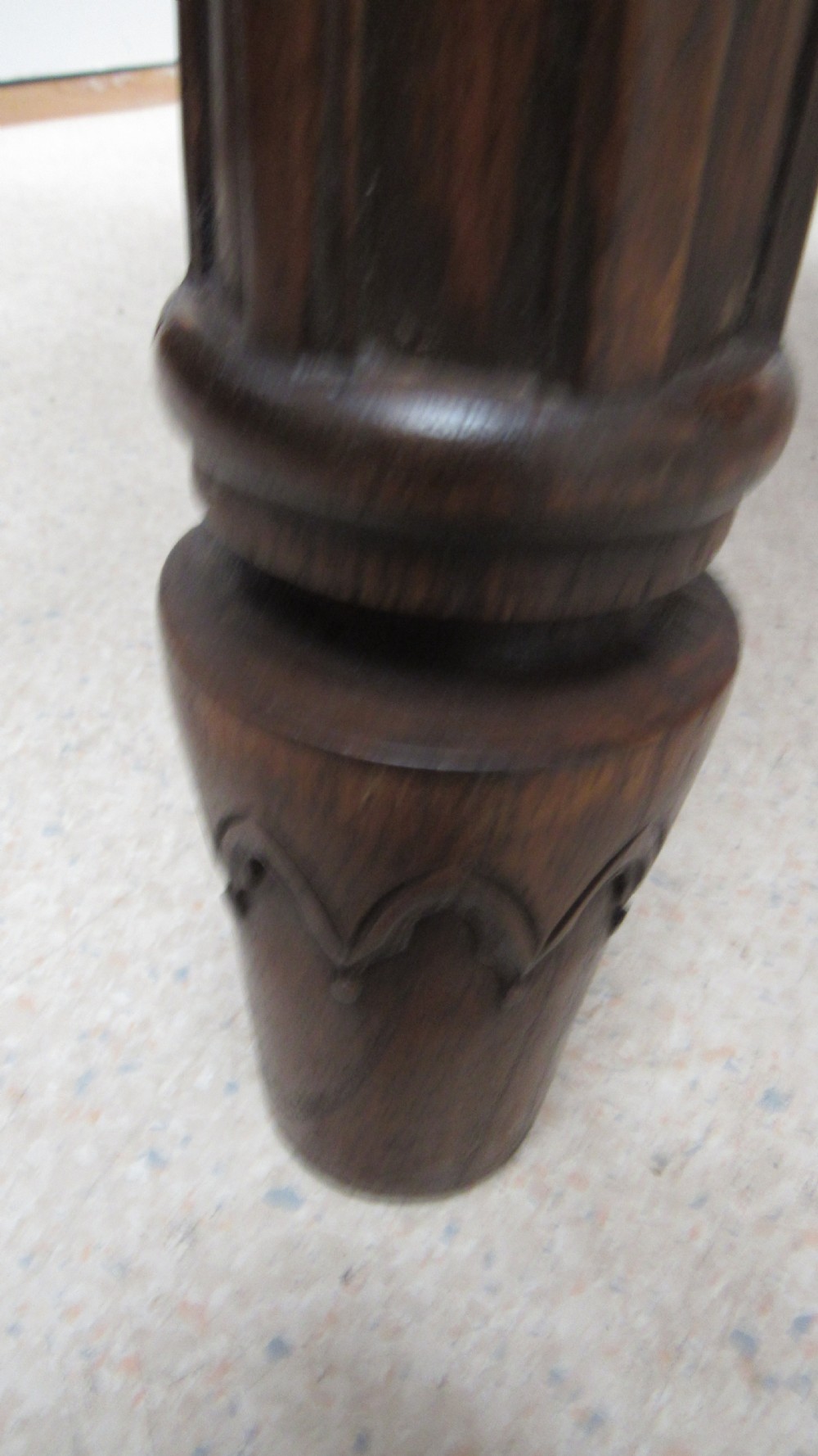 A rectangular solid oak refectory table featuring carved Gothic blind tracery along the frieze and turned column legs. View XVI