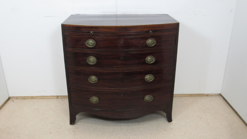 Elegant small bow front chest with a brushing slide