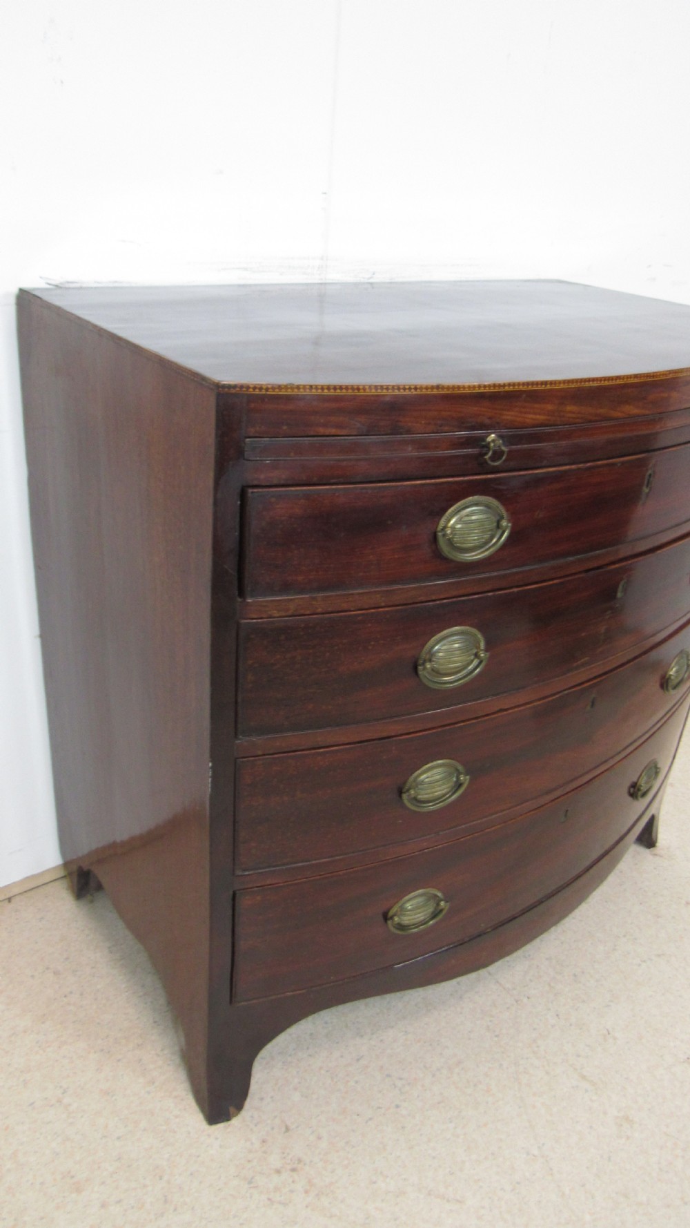 Elegant small bow front chest with a brushing slide View XII