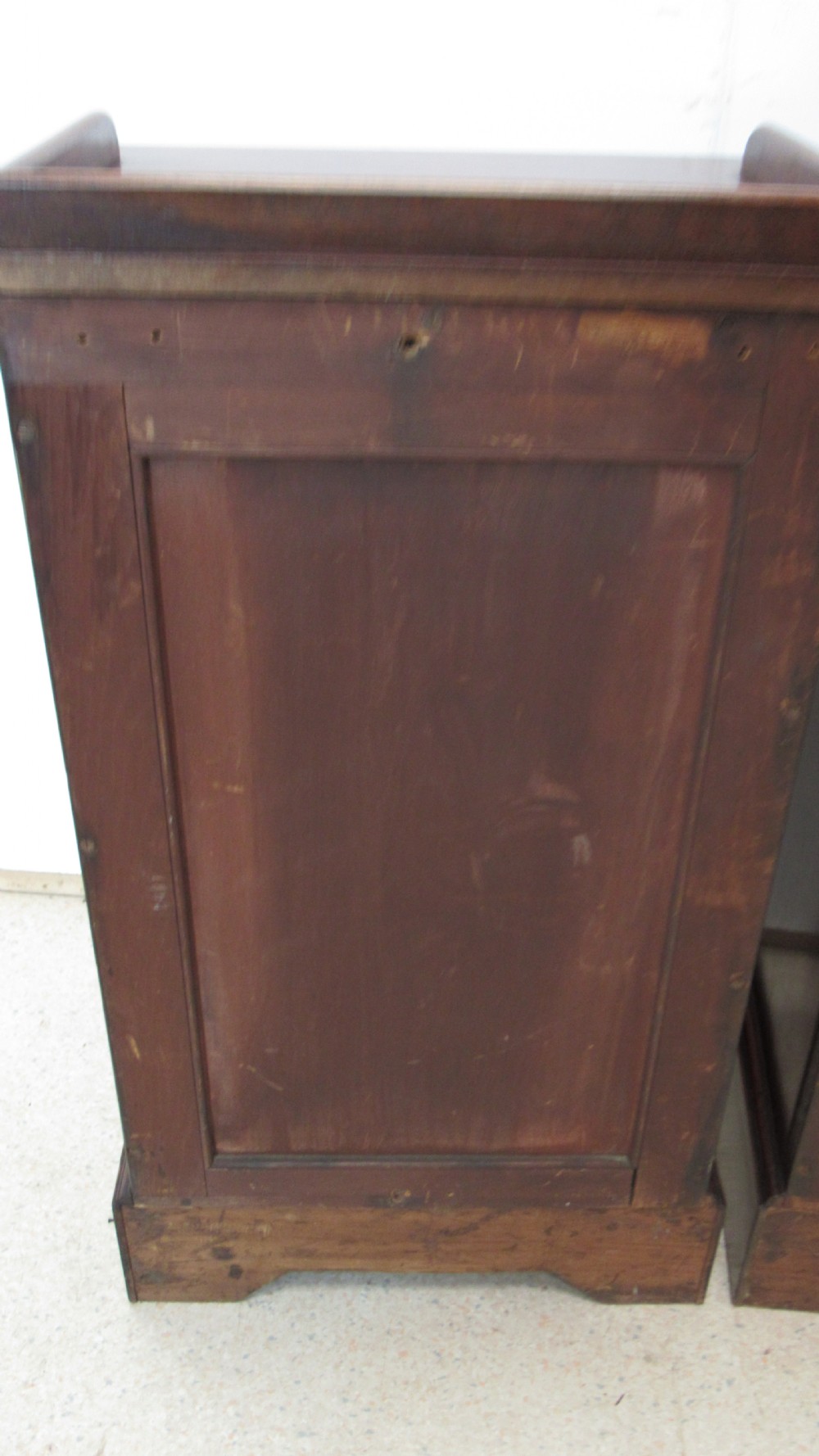 A pair of antique mahogany pot cupboards featuring three-sided gallery tops, single panelled doors with wooden knobs, and solid plinth bases. View XVI