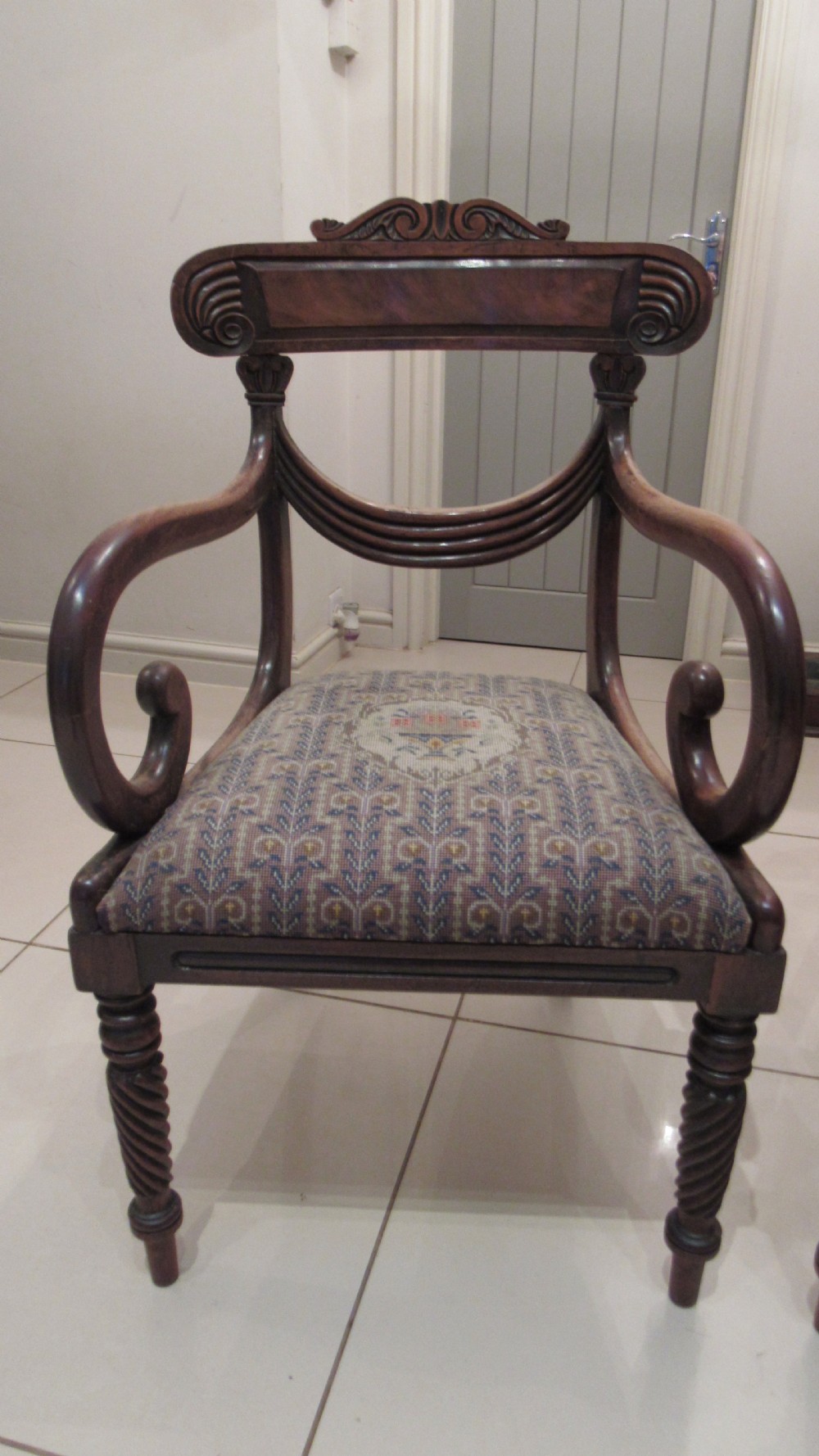 Pair of Regency mahogany carver chairs featuring curved scroll arms, reeded front legs, and patterned fabric seat upholstery. View VI