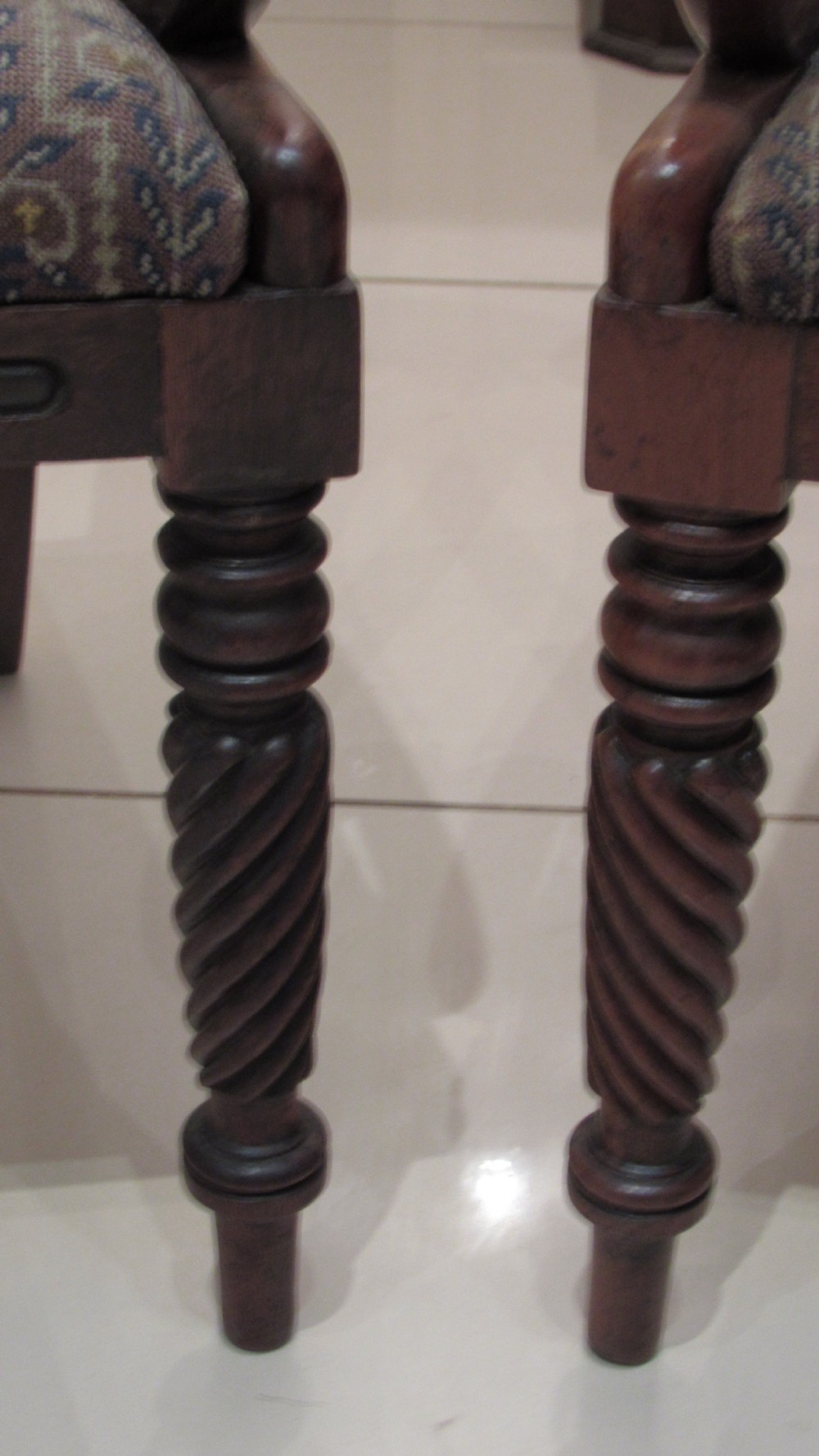 Pair of Regency mahogany carver chairs featuring curved scroll arms, reeded front legs, and patterned fabric seat upholstery. View VII