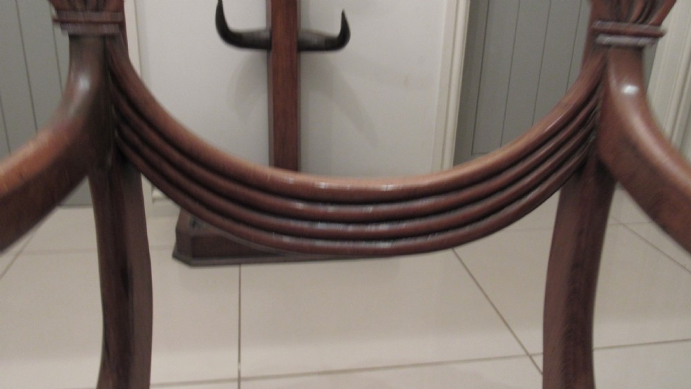 Pair of Regency mahogany carver chairs featuring curved scroll arms, reeded front legs, and patterned fabric seat upholstery. View XII