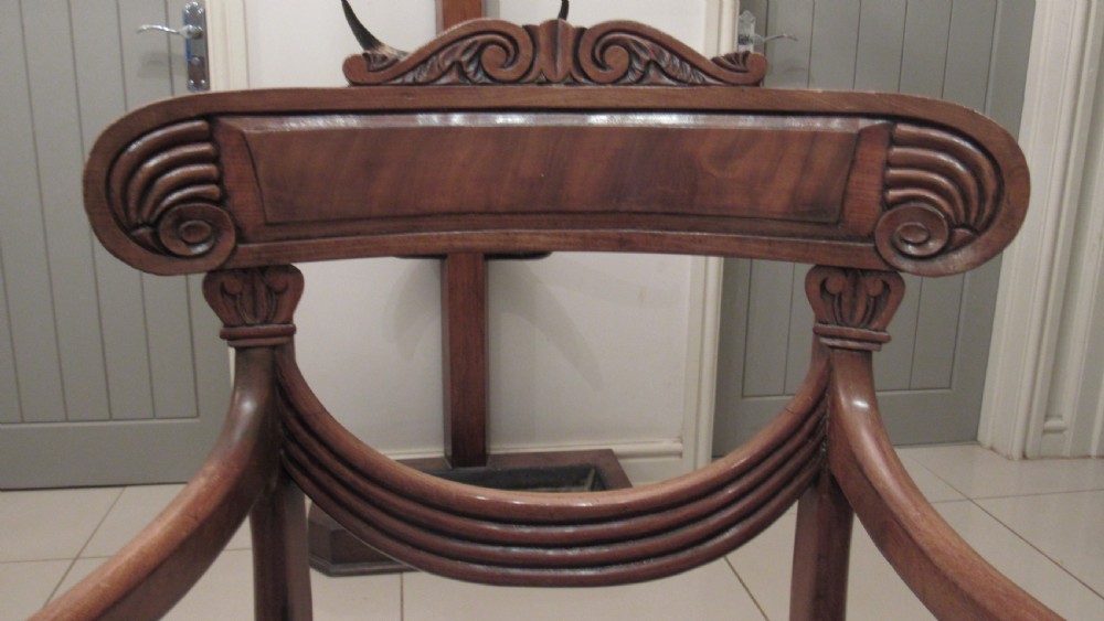 Pair of Regency mahogany carver chairs featuring curved scroll arms, reeded front legs, and patterned fabric seat upholstery. View XIII