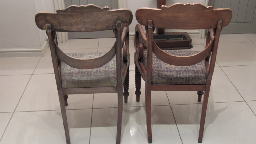 Pair of Regency mahogany carver chairs featuring curved scroll arms, reeded front legs, and patterned fabric seat upholstery. View XVI