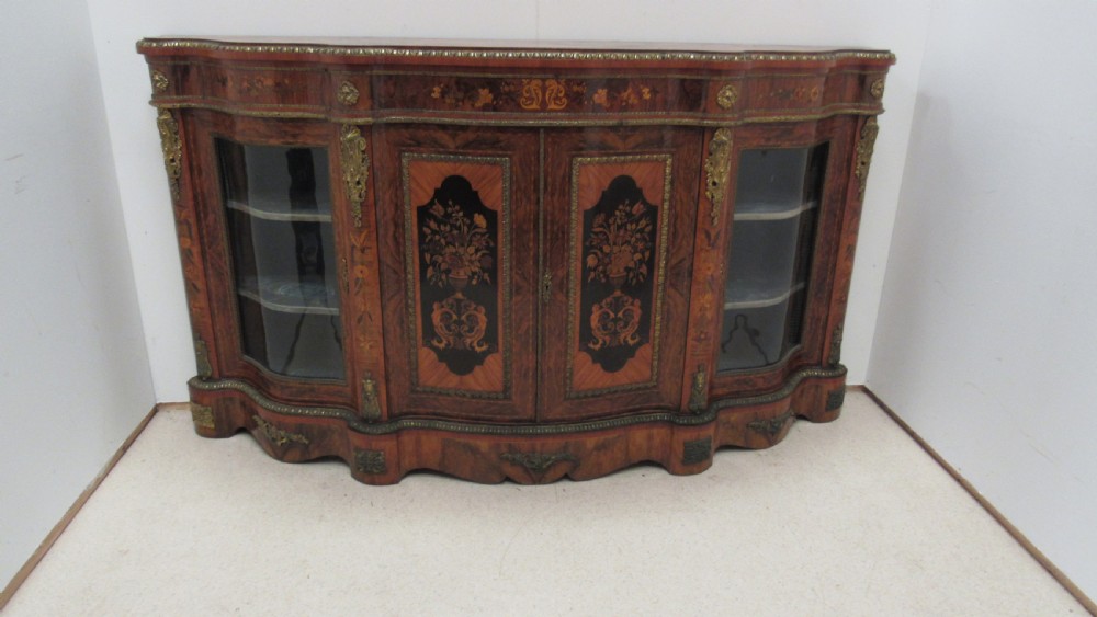 A Victorian serpentine-front credenza featuring central floral marquetry doors, glass display side cupboards, and ornate gilt-bronze mounts. View III
