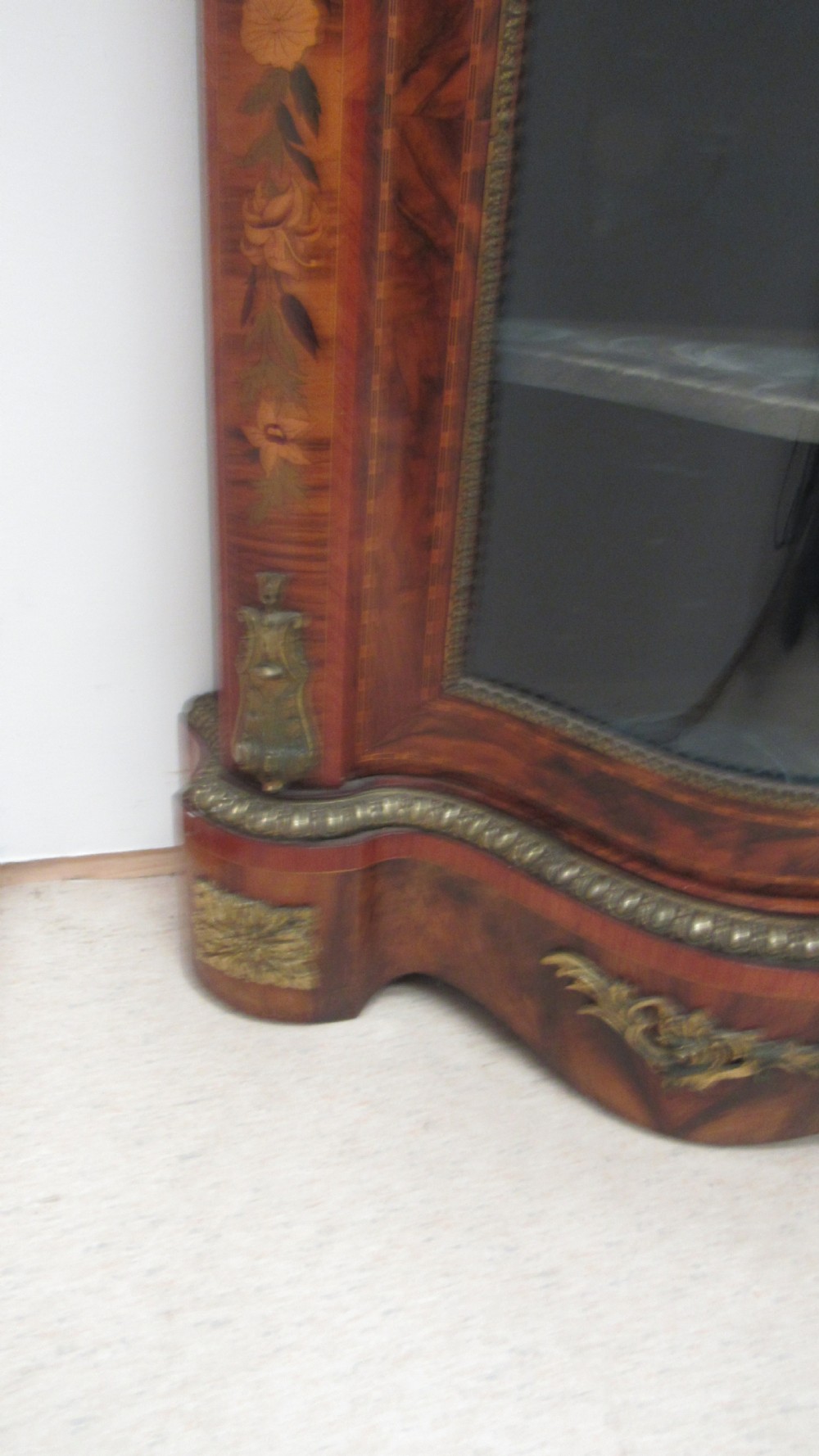 A Victorian serpentine-front credenza featuring central floral marquetry doors, glass display side cupboards, and ornate gilt-bronze mounts. View IX