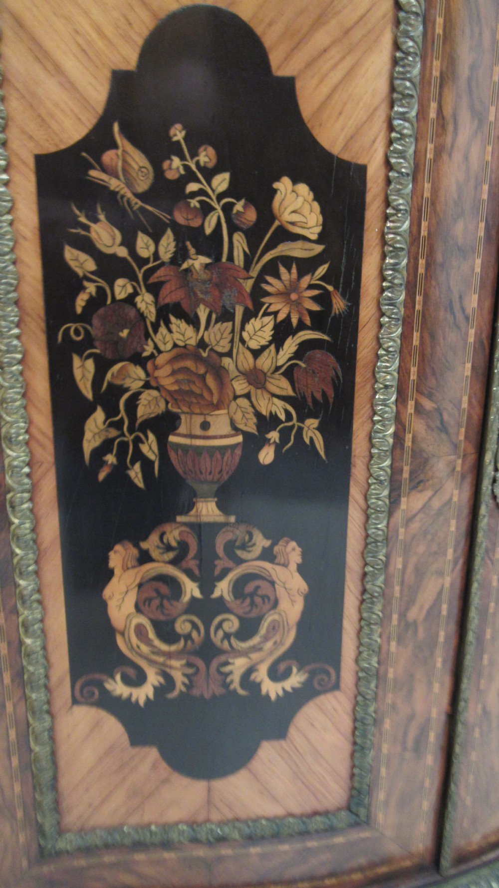 A Victorian serpentine-front credenza featuring central floral marquetry doors, glass display side cupboards, and ornate gilt-bronze mounts. View X