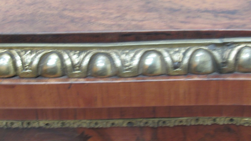 A Victorian serpentine-front credenza featuring central floral marquetry doors, glass display side cupboards, and ornate gilt-bronze mounts. View XVII