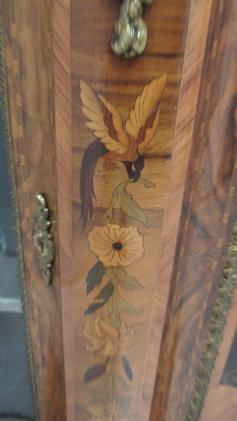 A Victorian serpentine-front credenza featuring central floral marquetry doors, glass display side cupboards, and ornate gilt-bronze mounts. View XX