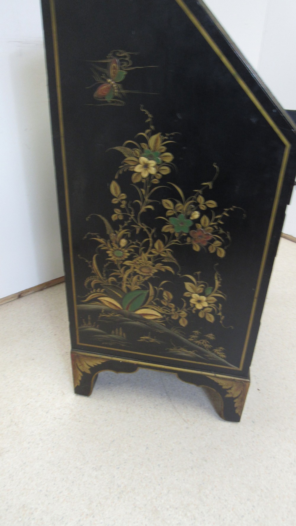 A black lacquered slant-front writing bureau decorated with detailed gold chinoiserie figurative landscapes and fitted with multiple drawers. View XIV