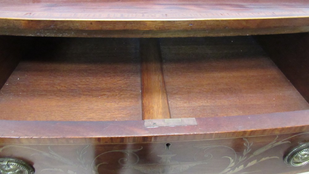 An antique mahogany sideboard with central drawer and side cupboards decorated with fine floral marquetry inlay on tapered legs. View X