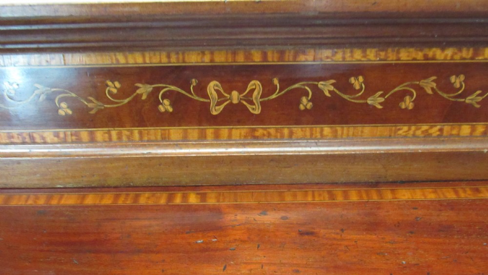 An antique mahogany sideboard with central drawer and side cupboards decorated with fine floral marquetry inlay on tapered legs. View XVII