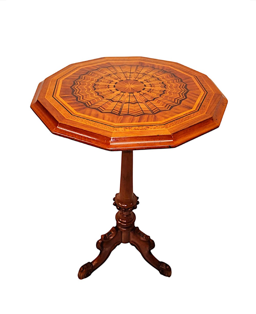 A nineteenth-century octagonal satinwood occasional table featuring a geometric marquetry top, turned central pedestal, and tripod scroll feet.