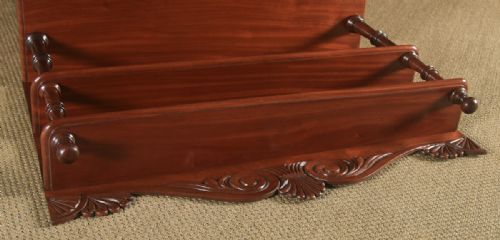 fig 3. A Regency mahogany two-door chiffonier cabinet featuring tiered upper display shelves, carved scroll cresting, and turned legs.