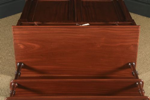 fig 5. A Regency mahogany two-door chiffonier cabinet featuring tiered upper display shelves, carved scroll cresting, and turned legs.