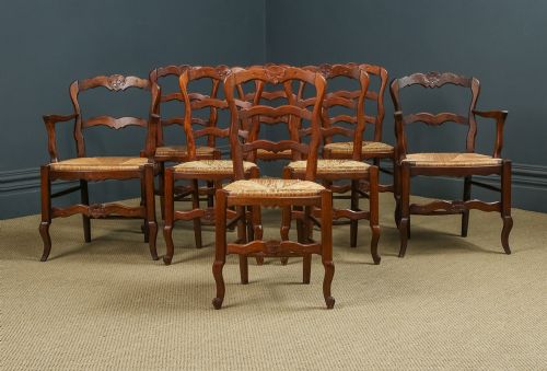 fig 2. A set of eight French provincial oak dining chairs featuring wavy ladder backrests, hand-woven rush seats, and carved cabriole legs.