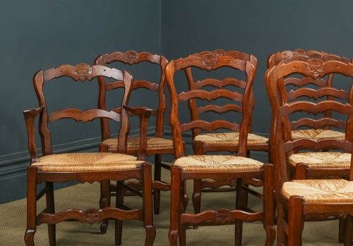 fig 3. A set of eight French provincial oak dining chairs featuring wavy ladder backrests, hand-woven rush seats, and carved cabriole legs.