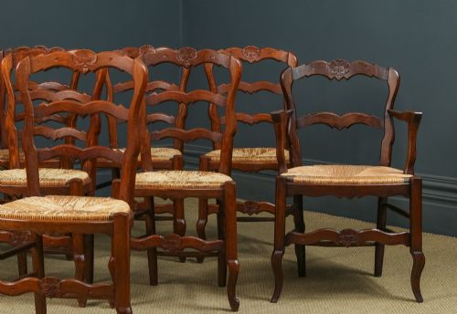 fig 5. A set of eight French provincial oak dining chairs featuring wavy ladder backrests, hand-woven rush seats, and carved cabriole legs.