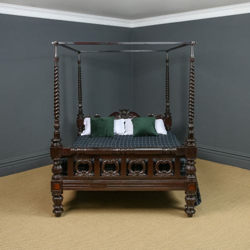 fig 1. A dark brown Anglo-Indian colonial four poster bed with spiral turned posts and a carved wooden footboard.