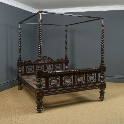 fig 2. A dark brown Anglo-Indian colonial four poster bed with spiral turned posts and a carved wooden footboard.