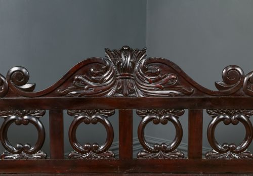 fig 8. A dark brown Anglo-Indian colonial four poster bed with spiral turned posts and a carved wooden footboard.