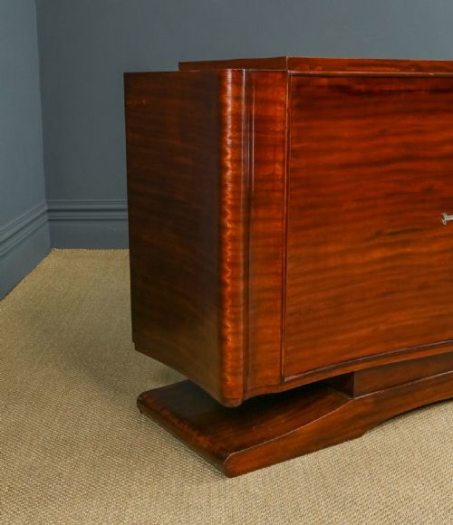 fig 6. An Art Deco mahogany sideboard featuring a serpentine front, central diamond parquetry door in maple, and streamlined metal handles.