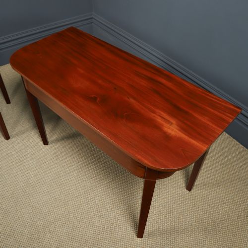 fig 4. A pair of Georgian mahogany D-shaped console tables standing on square tapered legs.