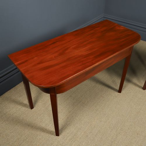 fig 5. A pair of Georgian mahogany D-shaped console tables standing on square tapered legs.
