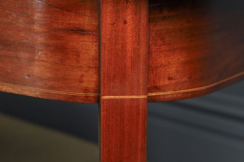 fig 7. A pair of Georgian mahogany D-shaped console tables standing on square tapered legs.
