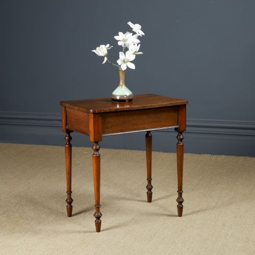 fig 1. A small rectangular Victorian oak side table with slender turned legs and a dark brown wax finish.