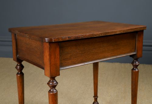 fig 3. A small rectangular Victorian oak side table with slender turned legs and a dark brown wax finish.
