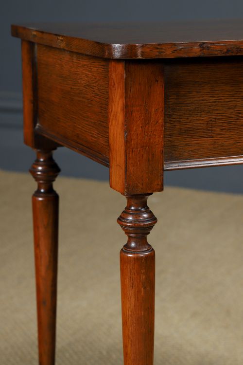 fig 4. A small rectangular Victorian oak side table with slender turned legs and a dark brown wax finish.