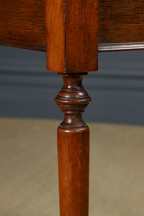 fig 5. A small rectangular Victorian oak side table with slender turned legs and a dark brown wax finish.