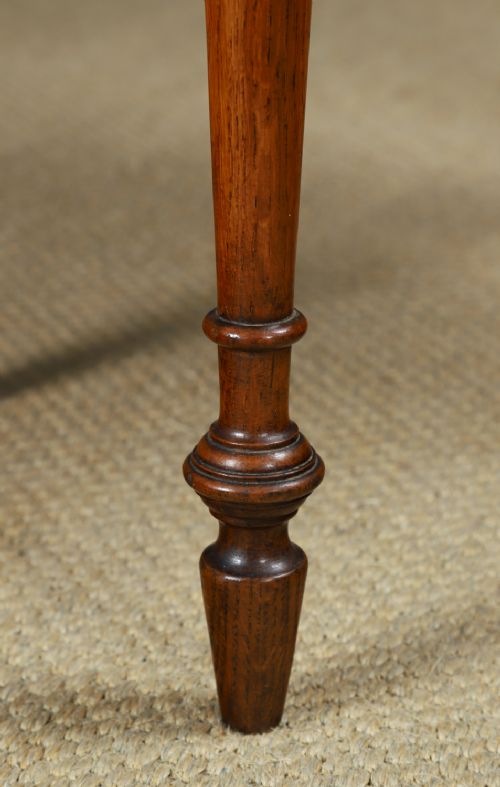 fig 6. A small rectangular Victorian oak side table with slender turned legs and a dark brown wax finish.