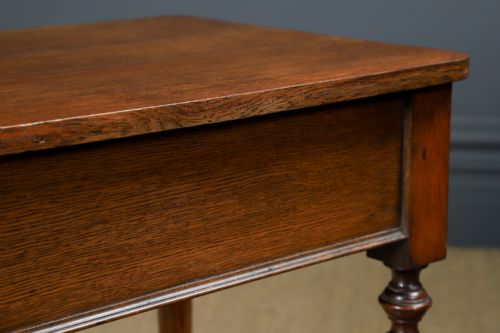 fig 7. A small rectangular Victorian oak side table with slender turned legs and a dark brown wax finish.