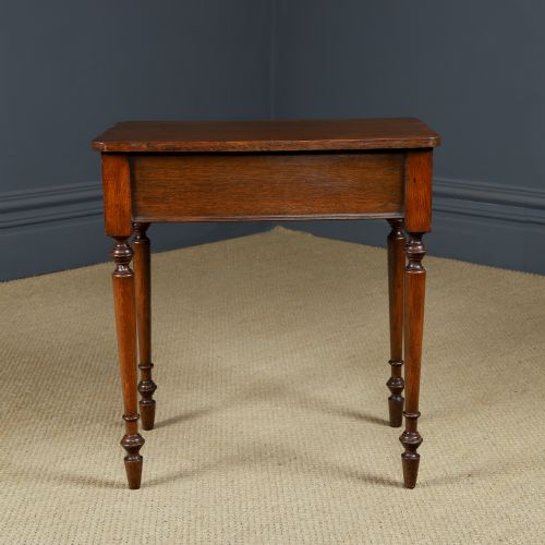 fig 8. A small rectangular Victorian oak side table with slender turned legs and a dark brown wax finish.