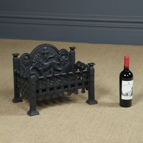 fig 1. A black cast iron fire grate featuring a relief-carved heraldic lion backplate and portcullis lattice front basket.