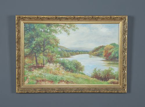 fig 1. A framed landscape painting depicting a serene river flowing through green foliage and trees, presented in an ornate gilt frame.