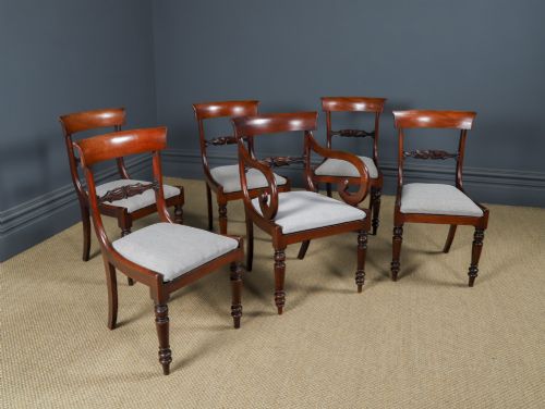 fig 1. A set of six mahogany Regency dining chairs featuring carved back rails, turned front legs, and light-coloured upholstered seats.