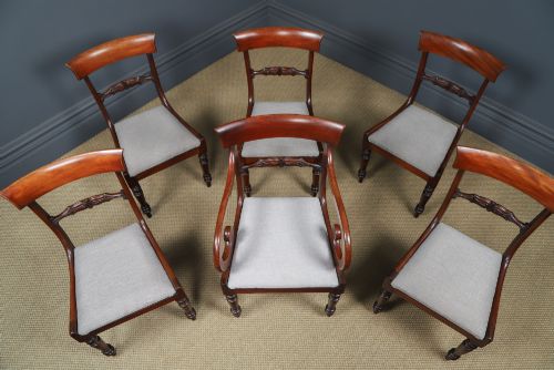 fig 6. A set of six mahogany Regency dining chairs featuring carved back rails, turned front legs, and light-coloured upholstered seats.