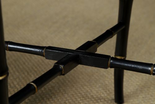 fig 4. An ebonised Victorian papier-mache tray table featuring gilt Chinoiserie decoration and a lion motif, resting on a faux-bamboo base.