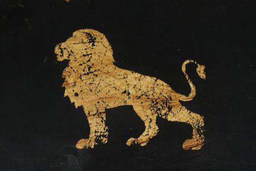 fig 6. An ebonised Victorian papier-mache tray table featuring gilt Chinoiserie decoration and a lion motif, resting on a faux-bamboo base.