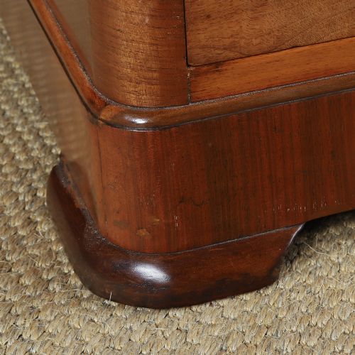 fig 4. An Art Deco burr walnut pedestal writing desk with green circular knobs and a fitted glass top.