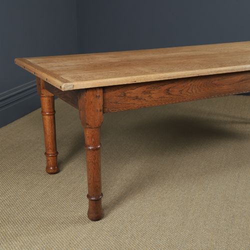fig 1. A long Victorian 19th-century refectory dining table with a light pitch pine top and dark oak frame on turned legs.