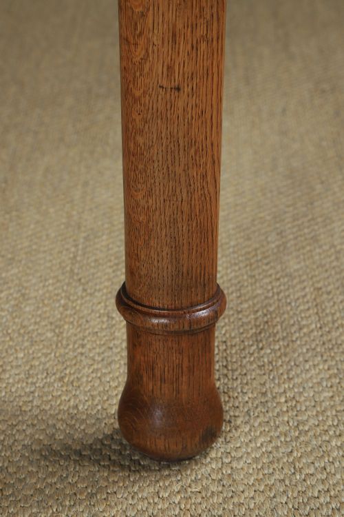 fig 4. A long Victorian 19th-century refectory dining table with a light pitch pine top and dark oak frame on turned legs.