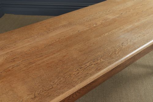 fig 5. A long Victorian 19th-century refectory dining table with a light pitch pine top and dark oak frame on turned legs.
