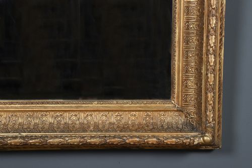 fig 4. A rectangular Victorian gilt wall mirror featuring a moulded frame with classical leaf and beaded details.