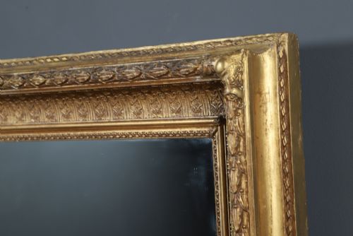 fig 6. A rectangular Victorian gilt wall mirror featuring a moulded frame with classical leaf and beaded details.